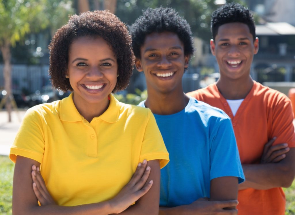 group of three african american young adults with crossed arms